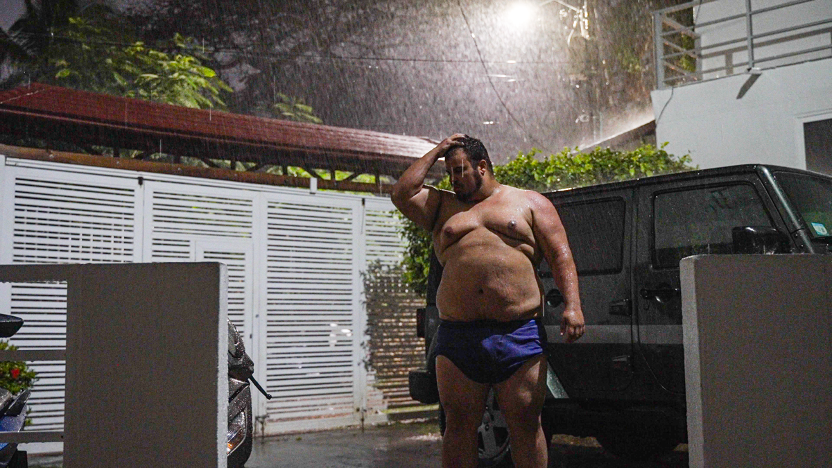 Coach is standing while raining.